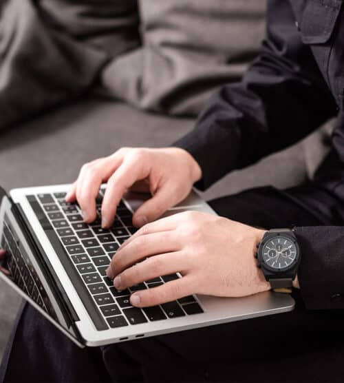 Policeman typing on a laptop