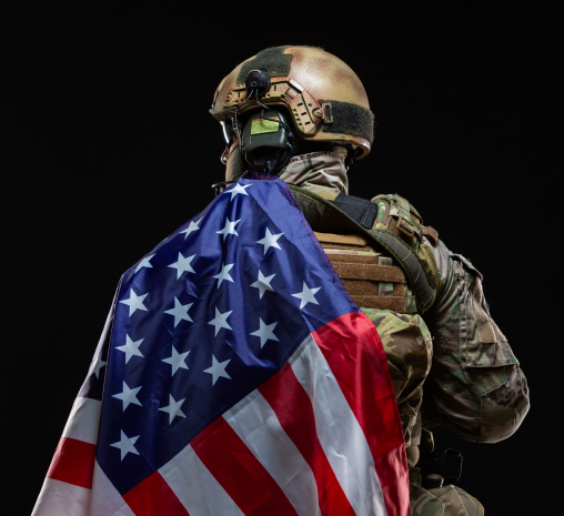 A soldier holding an American flag on a black background, showcasing the strong patriotic spirit of the military.